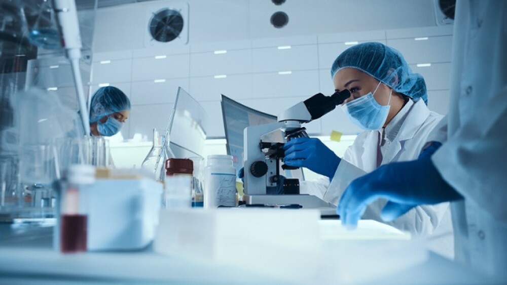 Young team during virus lab tests. Multi ethnic scientists focused on work. Wearing protective workwear