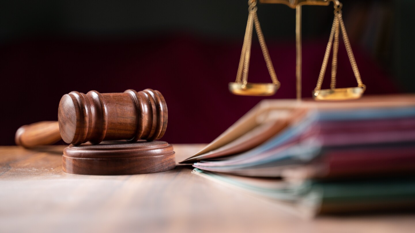 Photo of a judge's gavel, a balance and a stack of papers