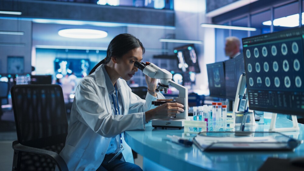 Photo of female scientist using microscope