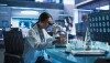 Photo of female scientist using microscope