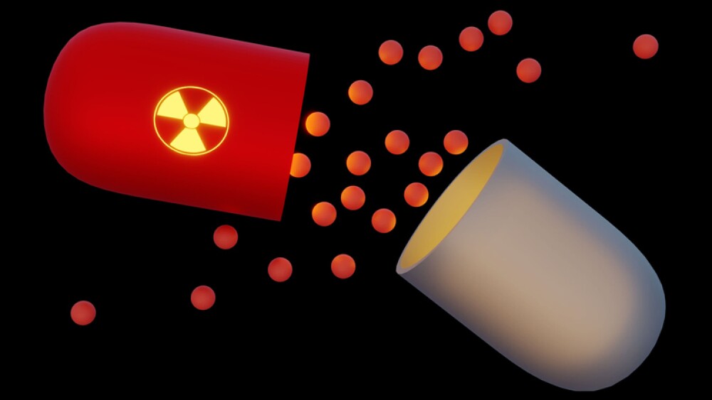 capsule with radioactive sign, broken open with medication spilling out
