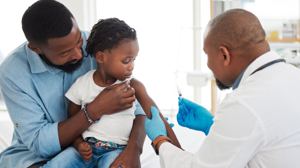 Healthcare, medical and doctor with kid patient and father holding baby for shot in hospital. Girl, children and family clinic nurse with vaccine for covid, virus or flu shot.