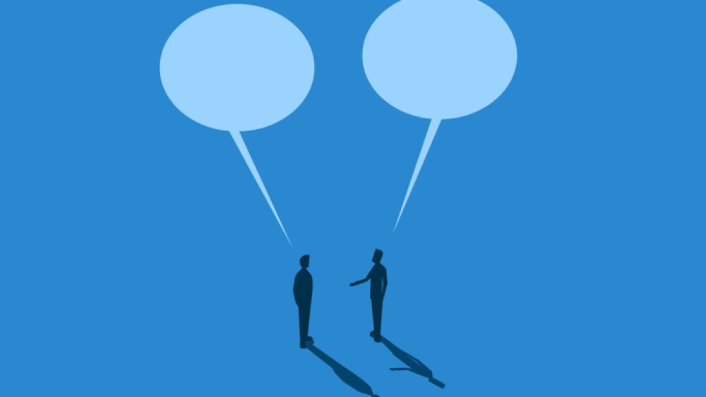 Two businessmen negotiating with big speech bubbles