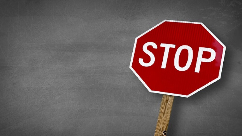 stop sign with black board backround