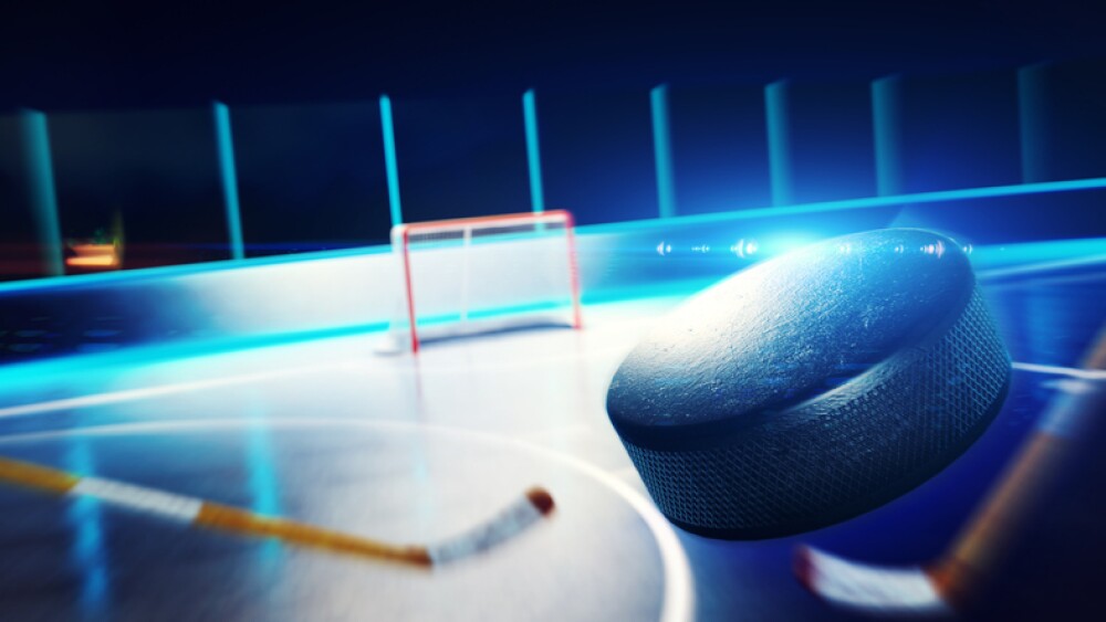 3d rendered illustration of hockey ice rink and goal. The puck is flying on goal.