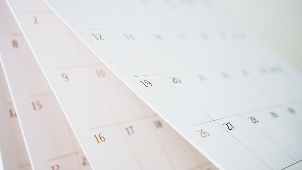 Calendar page flipping sheet close up blur background business schedule planning appointment meeting concept