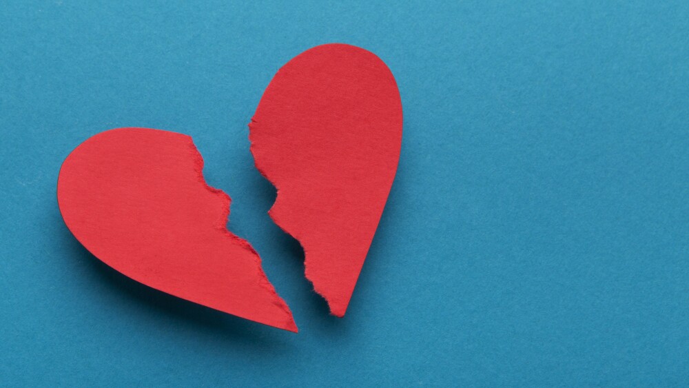 Sign of divorce. Broken paper heart on blue background, top view, copy space