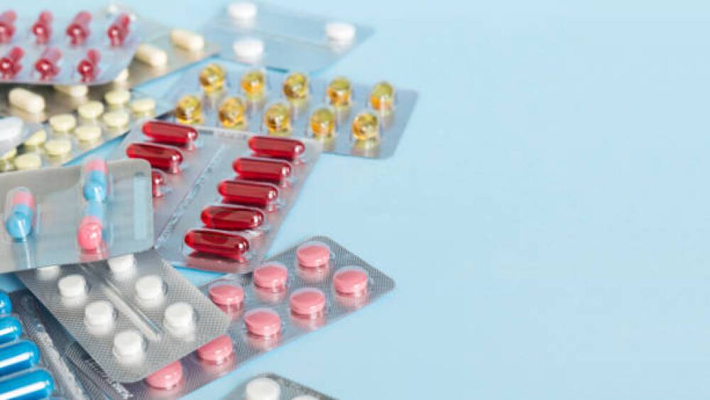 too many different pill of various blisters with different pills Medicines storage at home concept Medication storing. A pile of medicine in blister packs. Pharmaceutical blister packs.