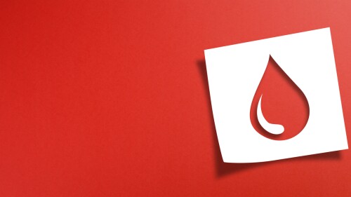 Note paper with blood donation concept on red background