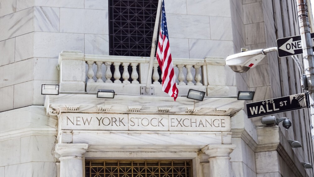 New York, United States - June 18, 2016: New York Stock Exchange with American flags and Wall street sign