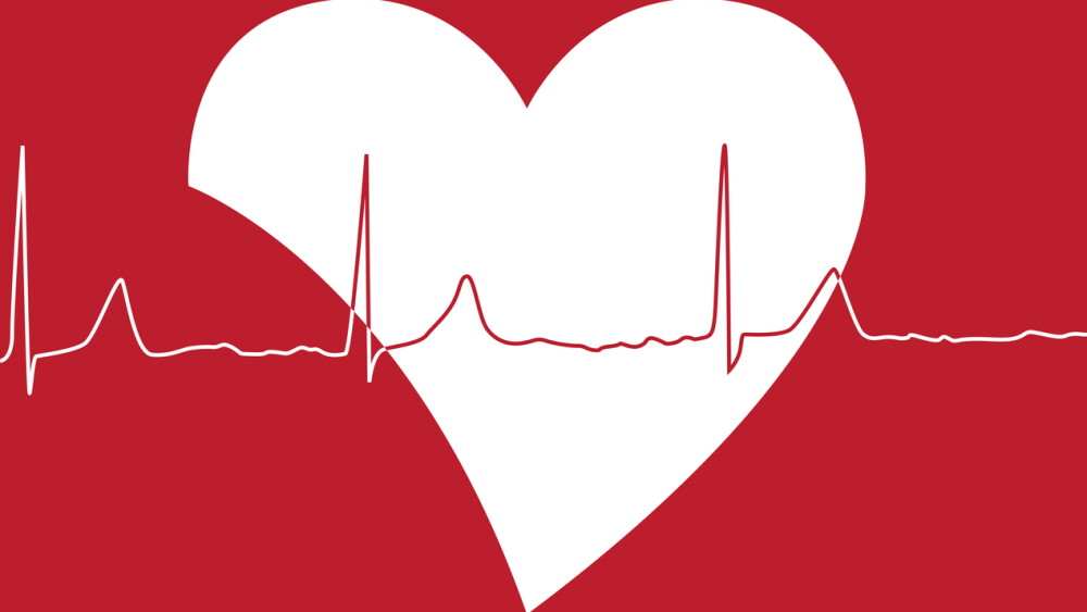 Big white heart shape with heartbeat on top of it on red background
