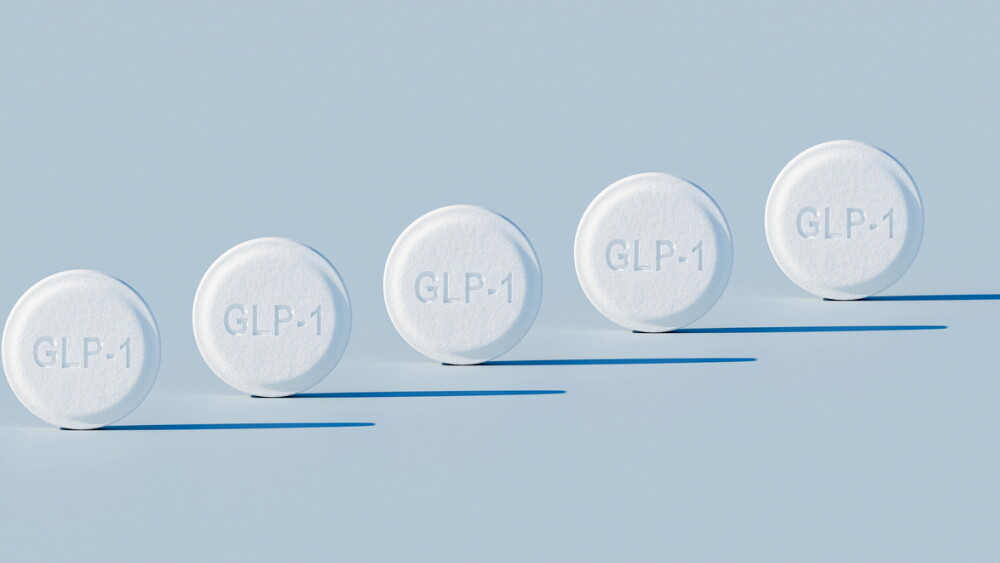 GLP-1 weighloss pills - five pills in a row on blue background with harsh lighting - orthographic perspective