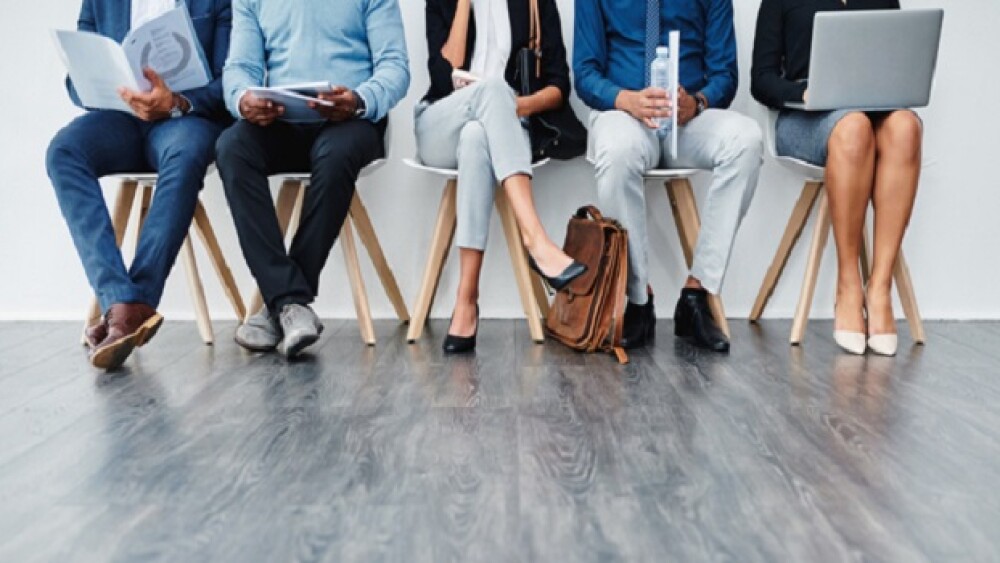 Cropped studio shot of a group of diverse businesspeople waiting in line