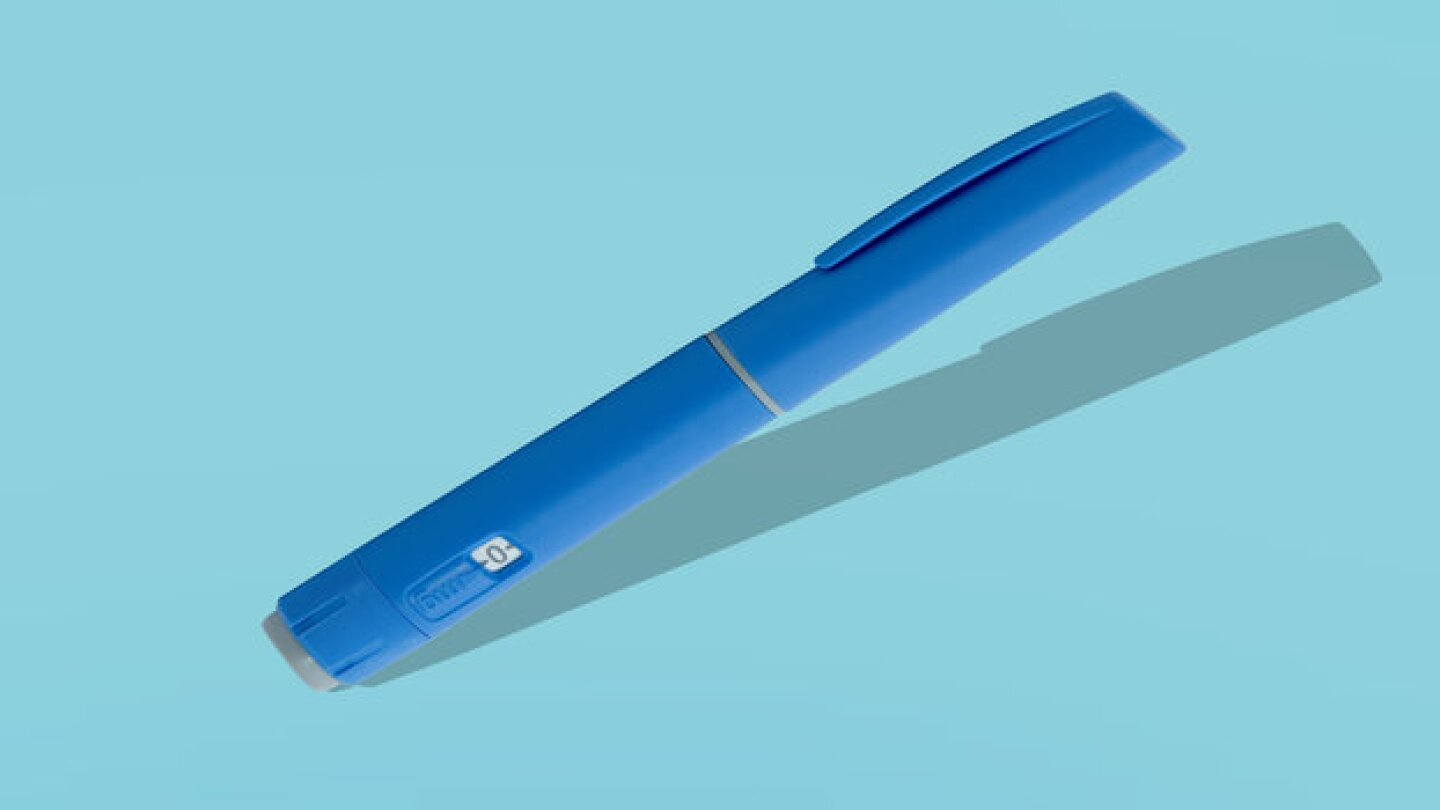 Photo of a GLP-1 injector pen on a blue background