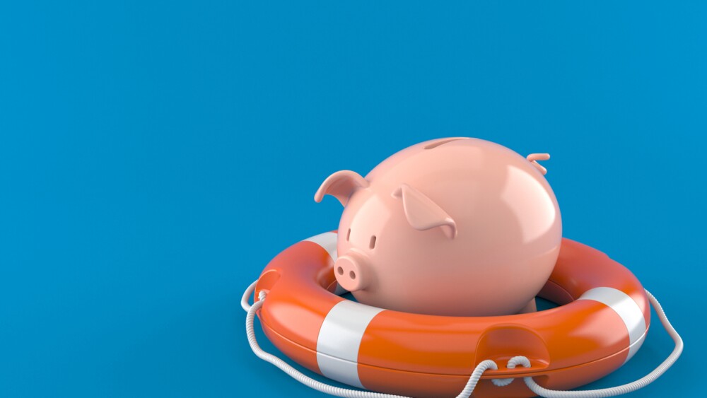 Piggy bank with life buoy isolated on blue background