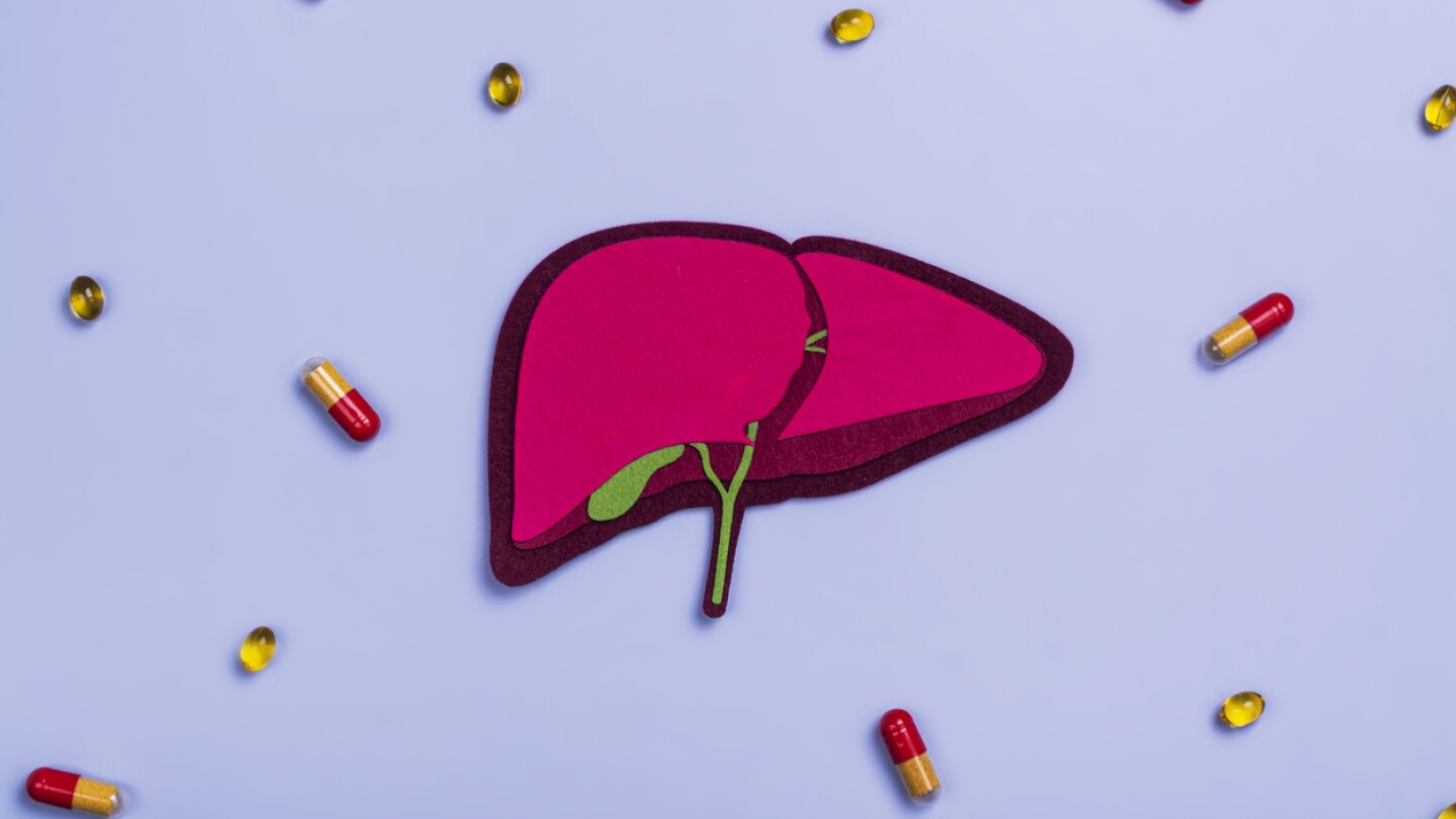 Human liver organ and pills. World hepatitis day. National liver health awareness month. Liver transplantation, donation background. Save patient life in hospital with liver transplant