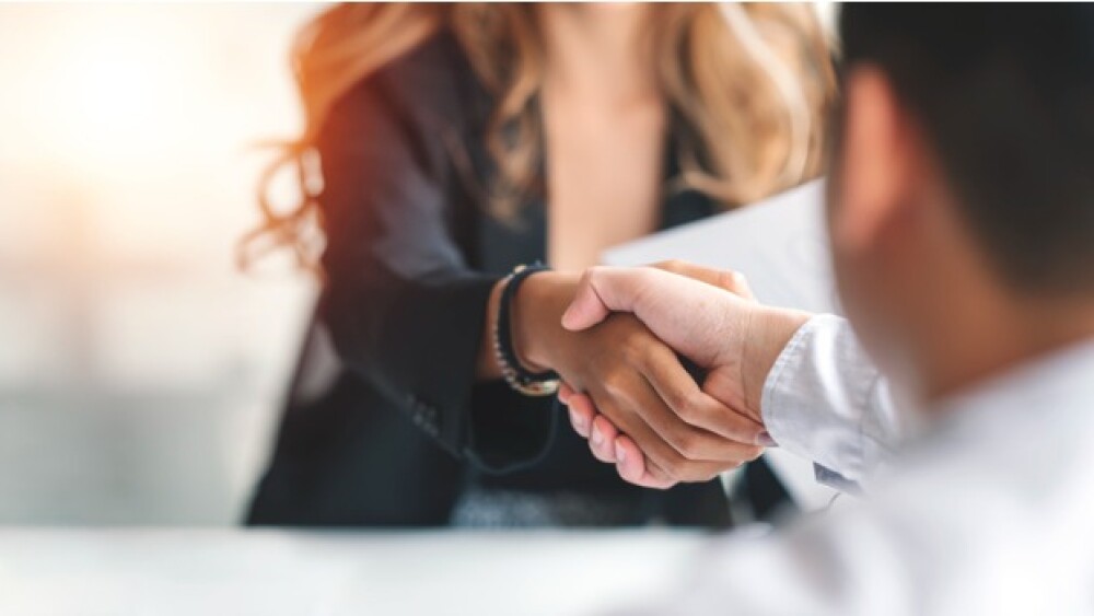 Pictured: A man and a woman shaking hands/iStock,