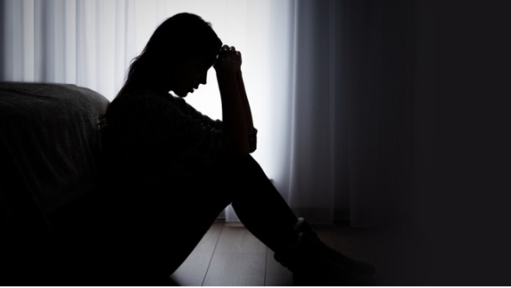 Pictured: A silhouette of a woman sitting on the f
