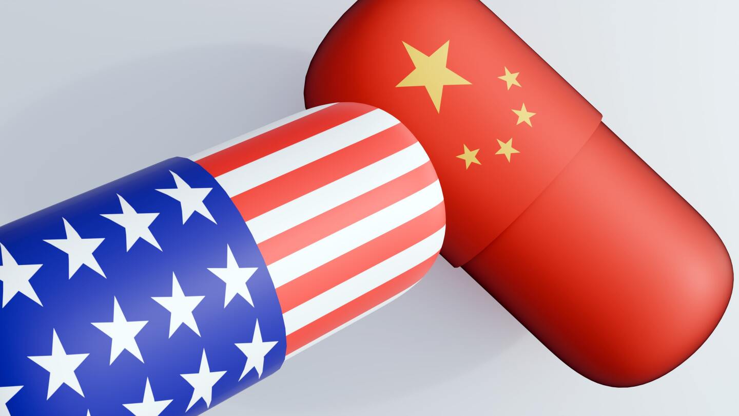 a 3D rendering of a capsule-shaped pill showcases the flag of United State of America and flag of China