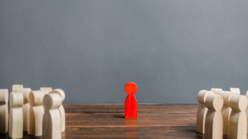 red figurine of a man stands aside from the crowd of people. Asociality, sociopathy. Rejected from society, lonely. Development of leadership and social qualities. Infected, fear and misunderstanding.