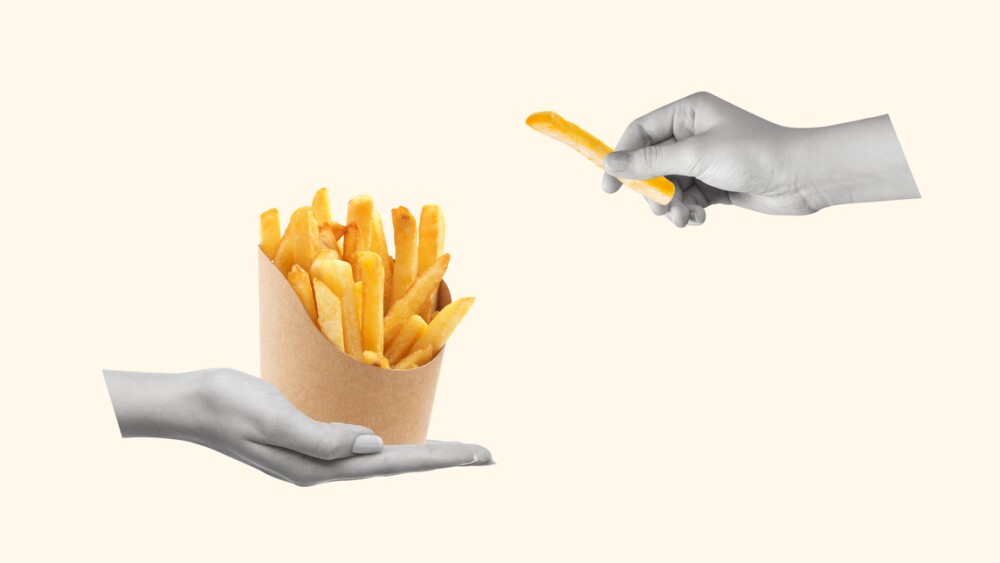 Сontemporary art collage of human hands holding french fries or chips. Modern design. Copy space for ad.