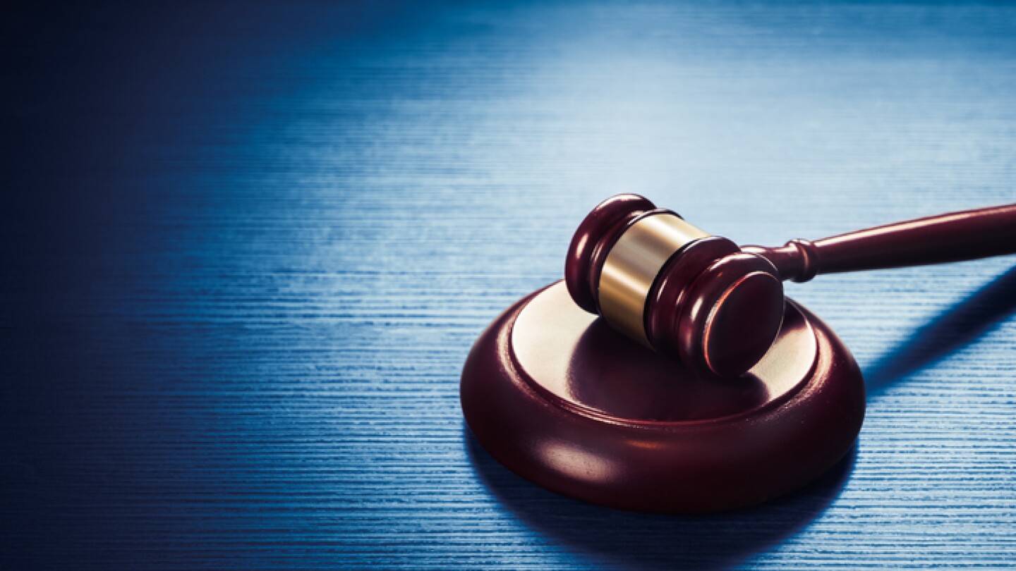 high contrast image of Judge gavel on a blue wooden background