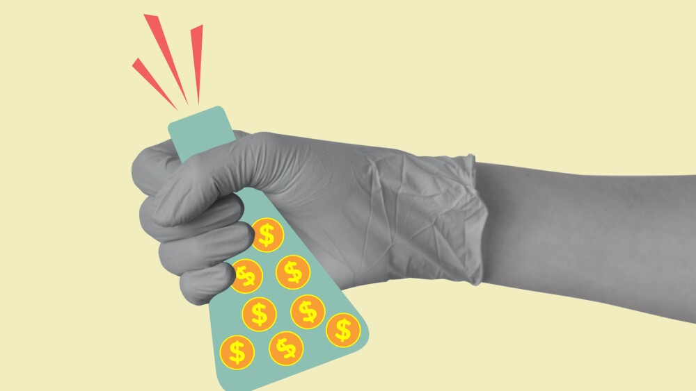 A hand in a medical or laboratory glove holds a laboratory flask with coins with dollar sign. Investments in laboratory research and science. Concept of profit, making money, business. Modern design. Copy space.