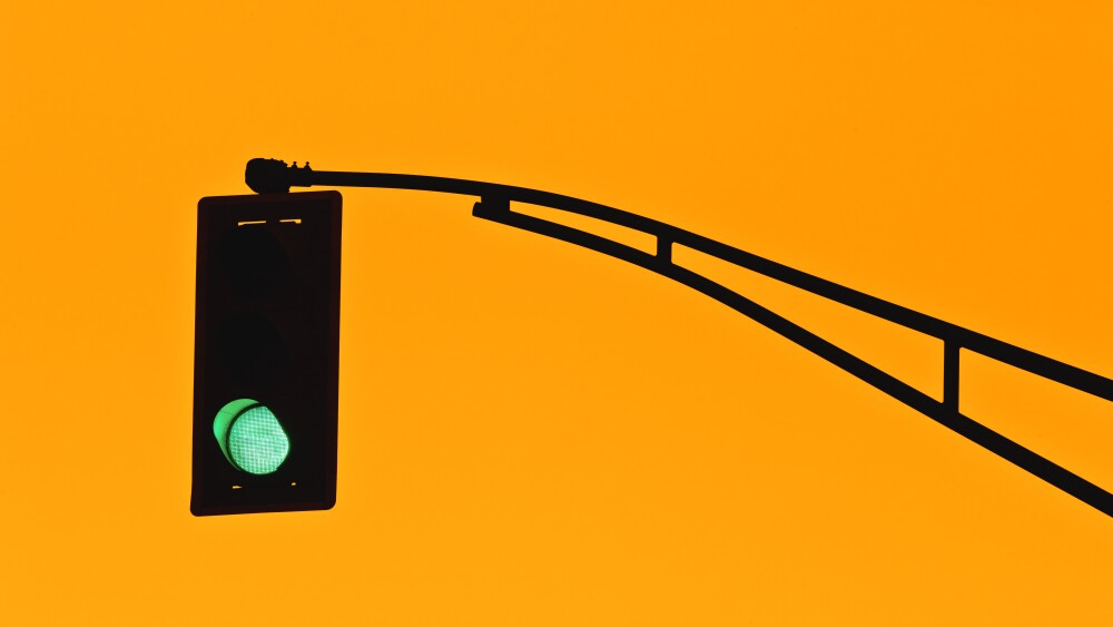 Traffic light silhouette and golden sky.
