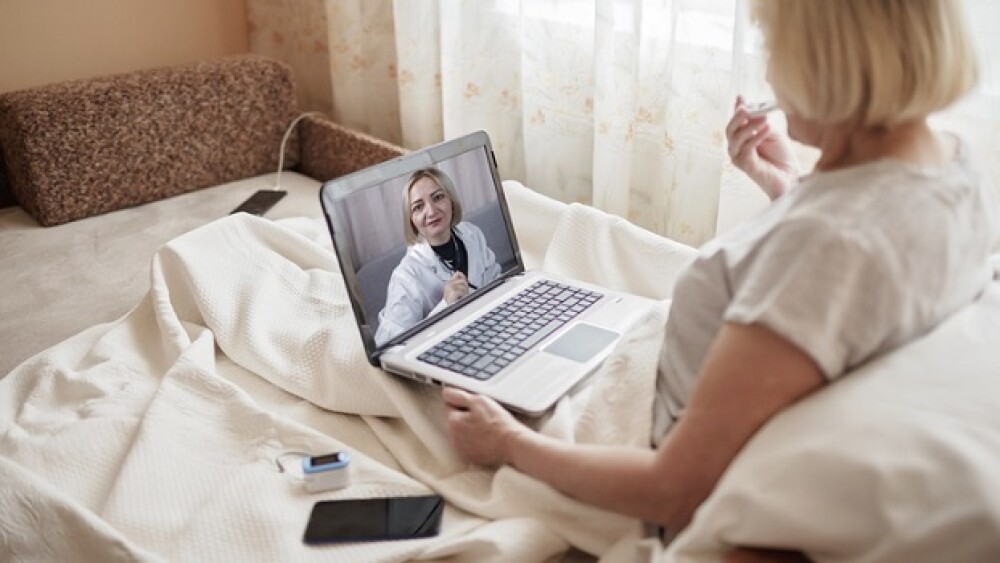 A patient takes her own vitals during a remote doc