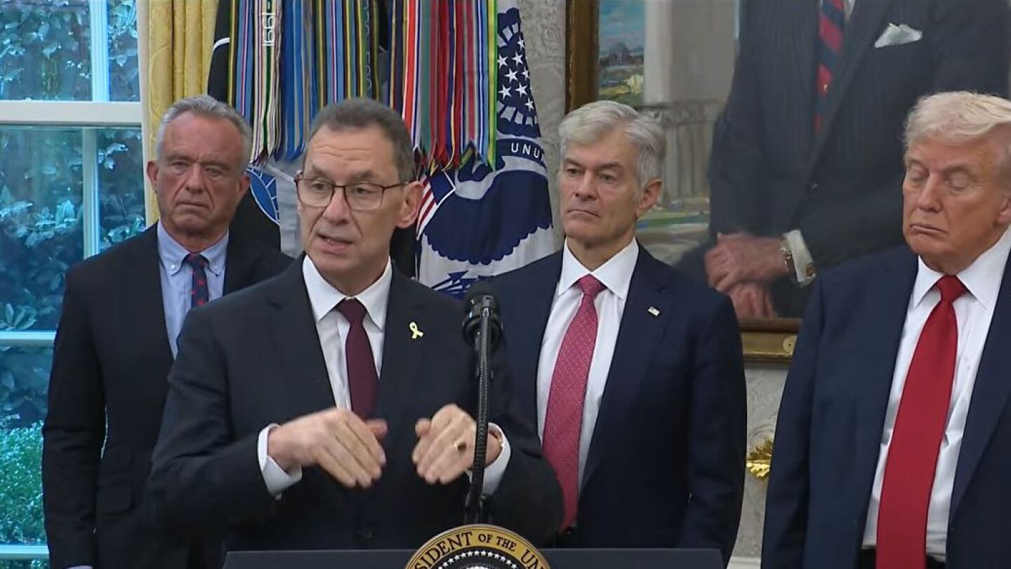 Pfizer CEO Albert Bourla speaks at the Oval Office, standing in front of a lectern next to President Donald Trump, Mehmet Oz, Robert F Kennedy Jr