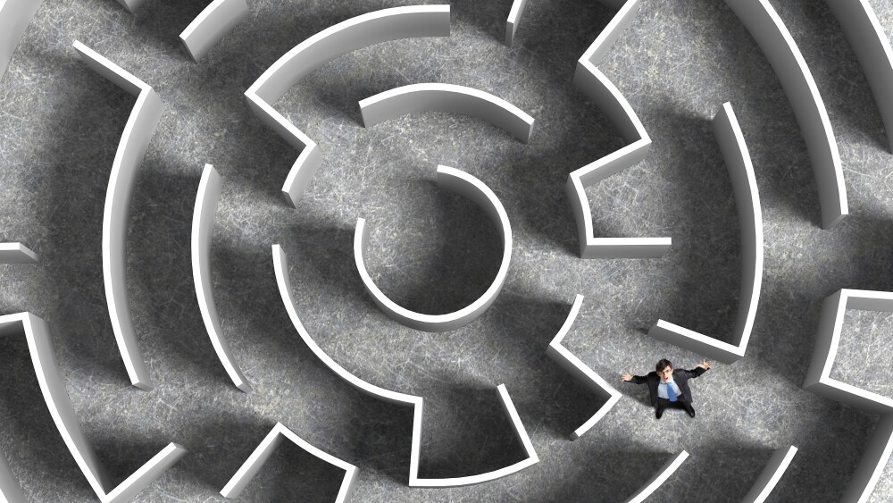 Top view of successful businessman lost in labyrinth