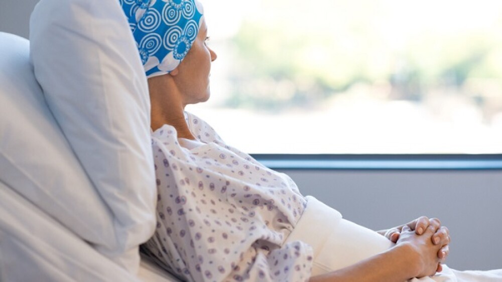 Pictured: Cancer patient in bed looking out window