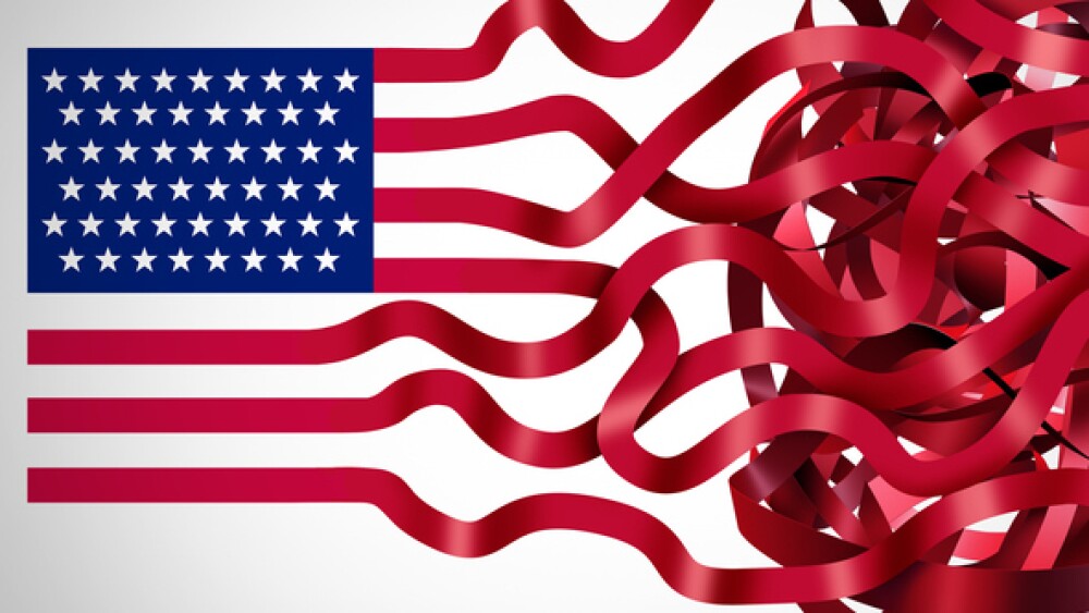 Government red tape concept and American bureaucracy symbol as an icon of the flag of the United States with the red stripes getting tangled in confusion as a metaphor for political and administration inefficiency.